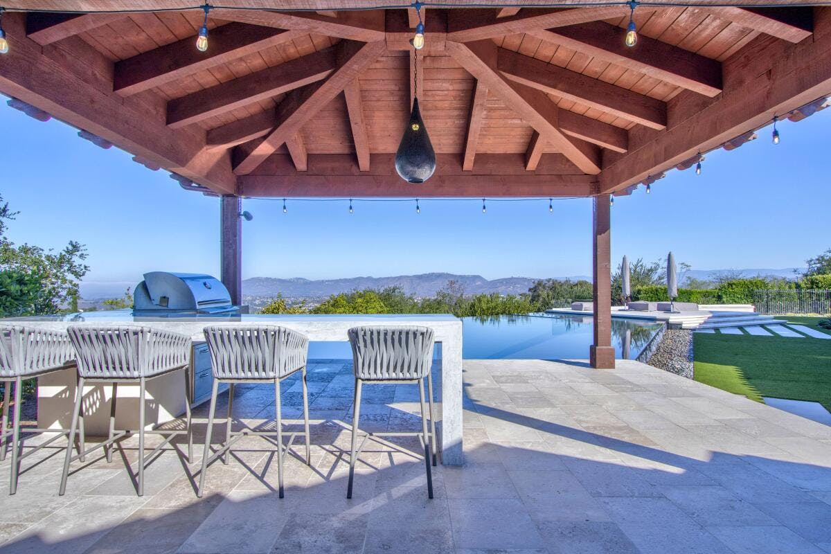 Covered patio with stylish seating at Venetian Point Loma, ideal for upscale events.