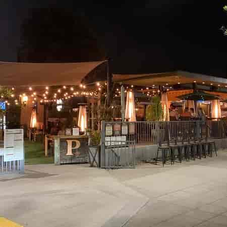 Vibrant outdoor venue with string lights for evening receptions and networking events.