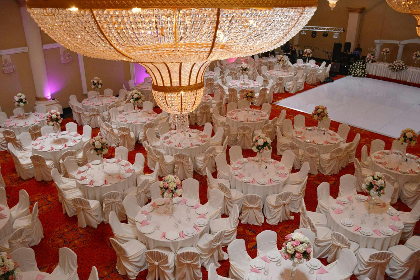 Elegant banquet hall with round tables, ideal for weddings and formal events.