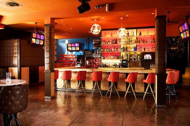 Modern lounge with colorful lighting, ideal for networking events and social gatherings.