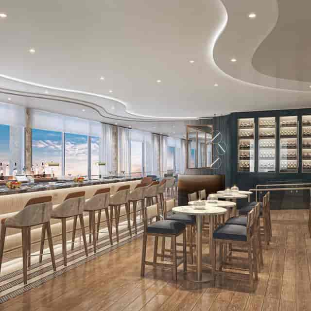 Modern event space with sleek bar and large windows for networking or cocktail receptions.