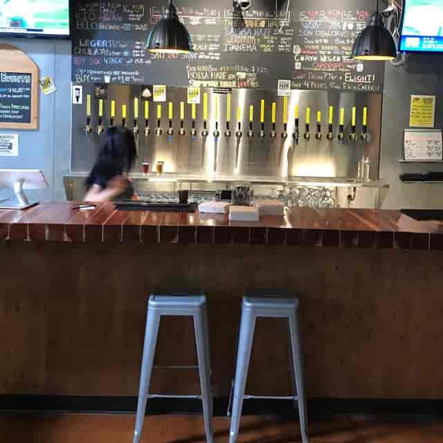 Tasting Room at Novo Brazil Brewing with sleek bar and beer taps for networking events.