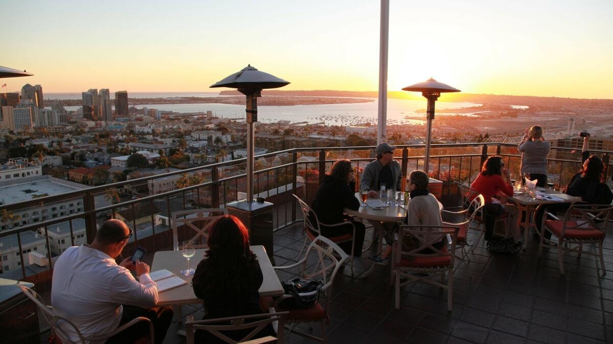 Outdoor deck at Mister A's Restaurant with sunset view, perfect for upscale events.