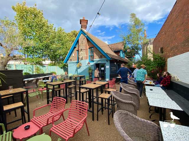 Vibrant outdoor restaurant venue with colorful decor for casual meetings and events.