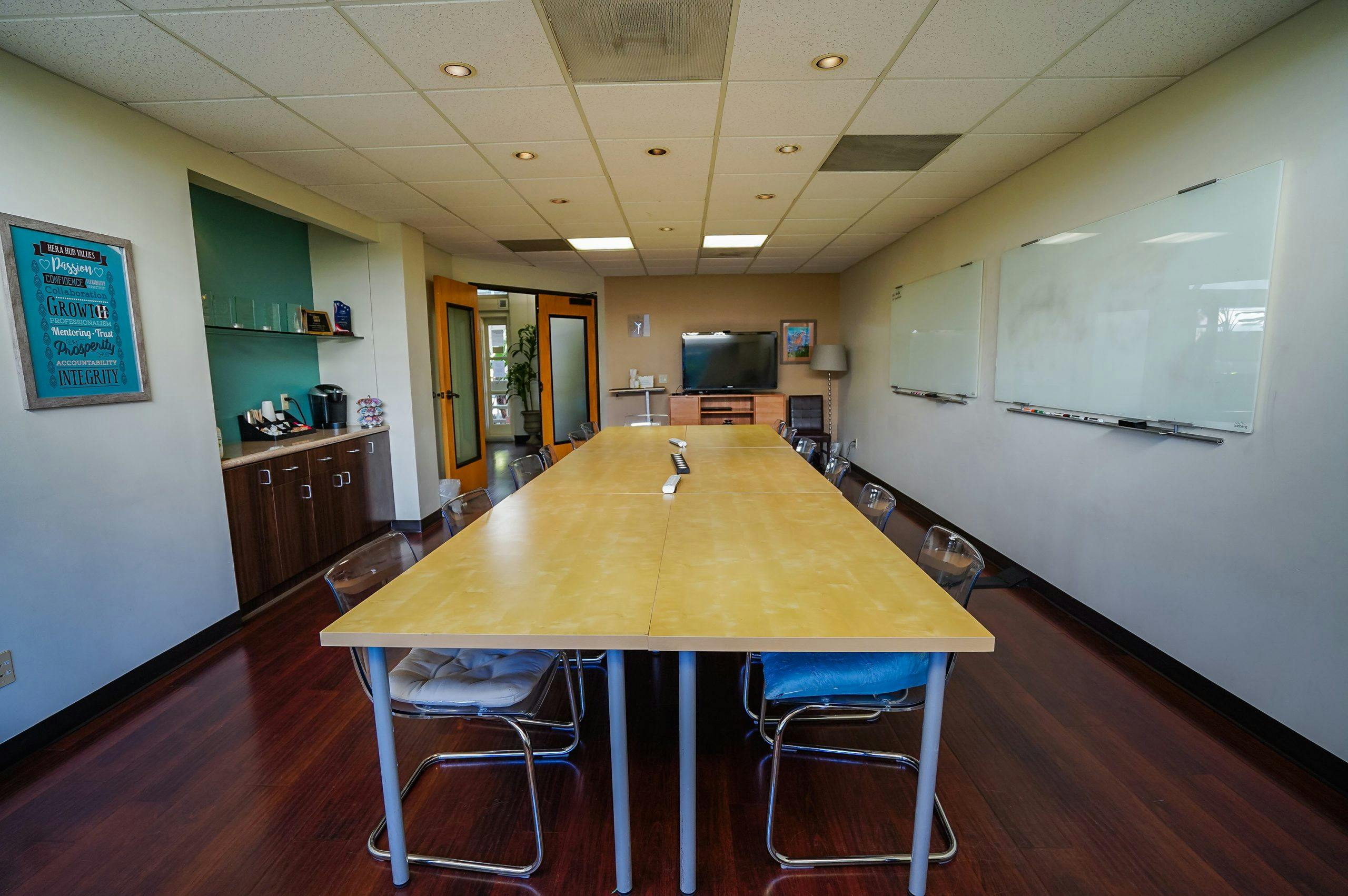 Brown Meeting Room at Hera Hub: bright, collaborative space for meetings and brainstorming.