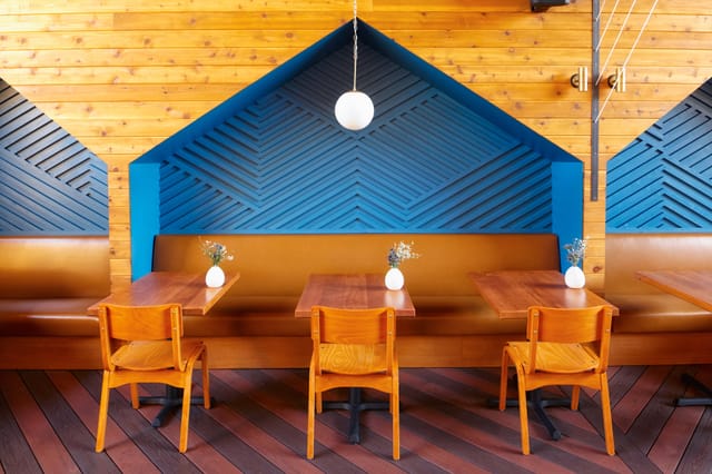Modern Madison restaurant with warm wood tones, ideal for intimate meetings and events.