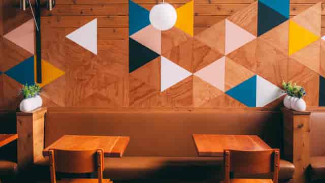 Modern Madison restaurant with geometric wall, ideal for casual meetings and events.