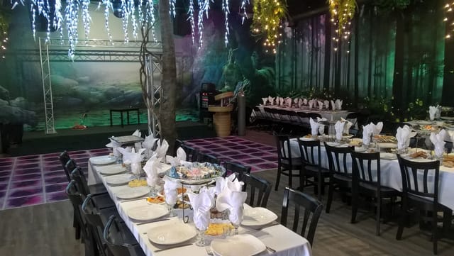 Elegant banquet hall with white linens, perfect for weddings and corporate events.