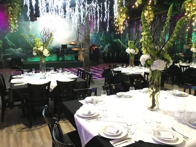 Elegant banquet hall dining setup with floral centerpieces for events and celebrations.