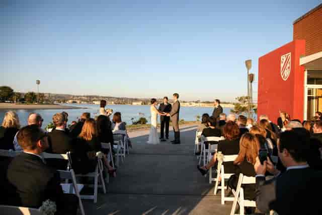 Outdoor wedding ceremony at Mission Bay, San Diego with elegant seating and scenic backdrop.