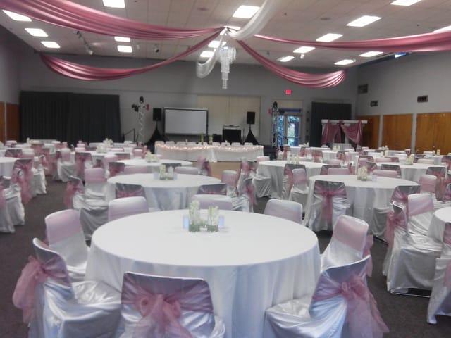 Arbor View Room in La Mesa: elegant event space for weddings with pink sashes and draped ceiling.