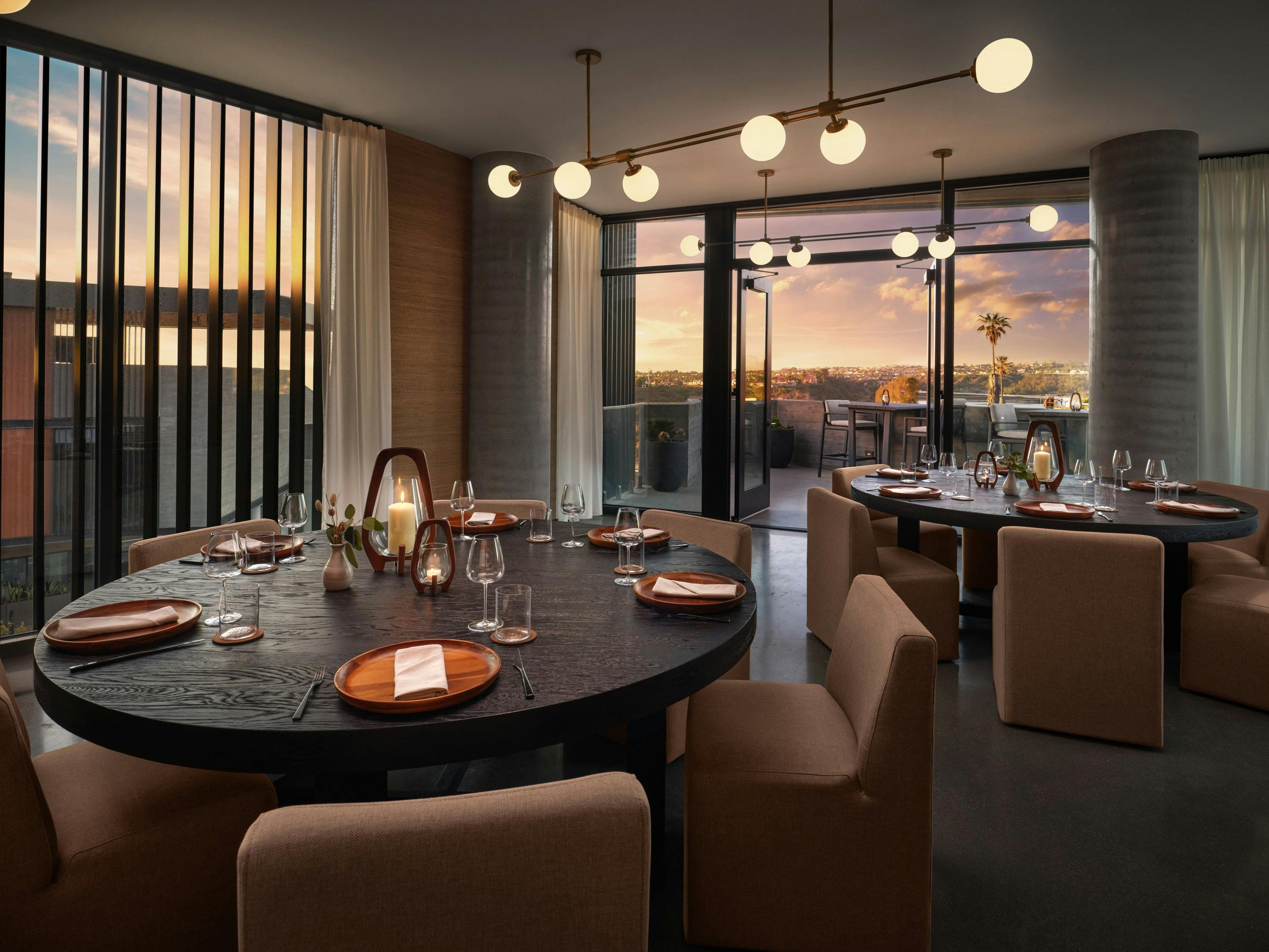 Private dining room with round table, elegant decor for upscale events and intimate meetings.