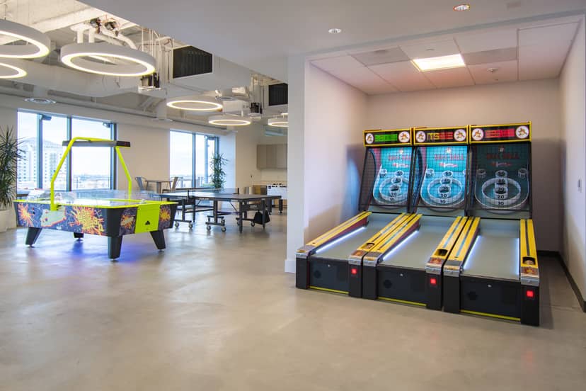 Modern glass-enclosed board room with air hockey for team-building events.