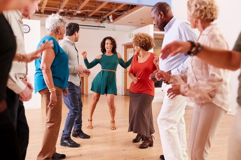 Lively dance studio with diverse participants for team-building workshops and social events.