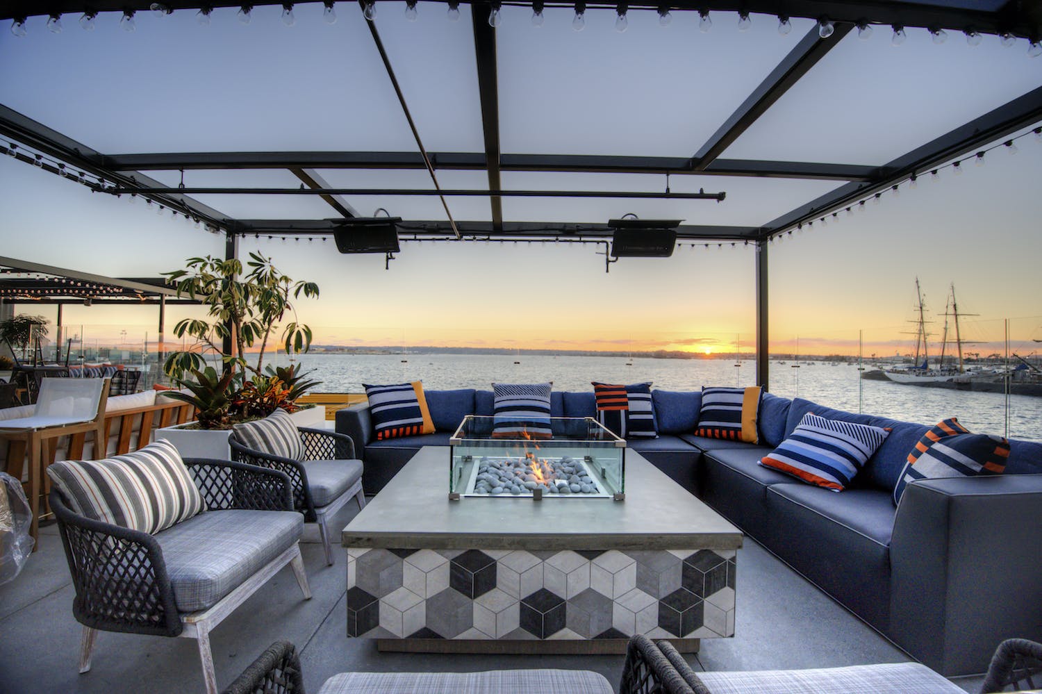Stylish outdoor patio with fire pit, perfect for networking events and sunset receptions.