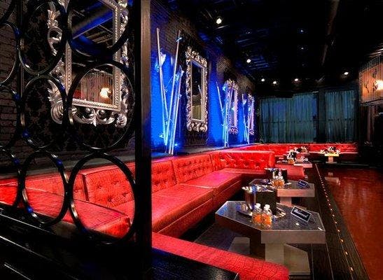 Stylish event space with plush red seating, ideal for networking and private parties.