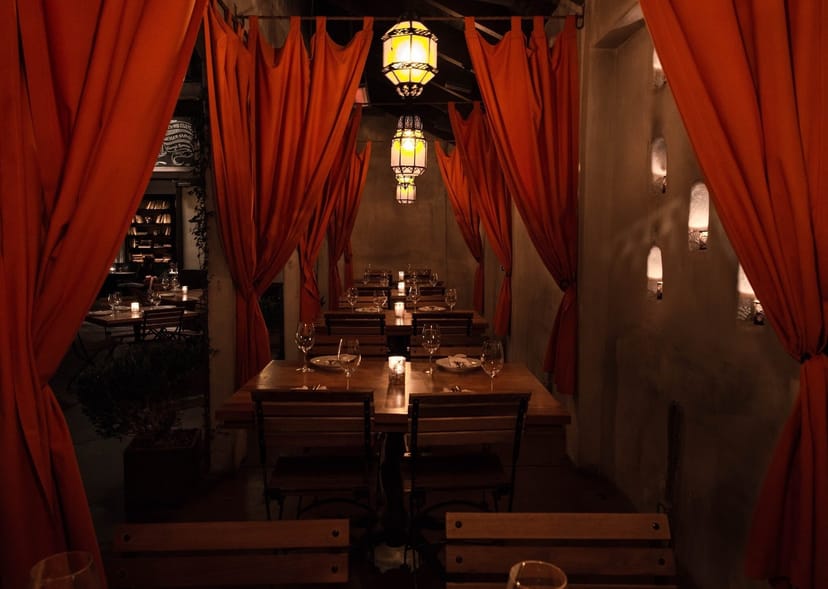 Cozy patio dining area with warm lighting, ideal for private events and gatherings.