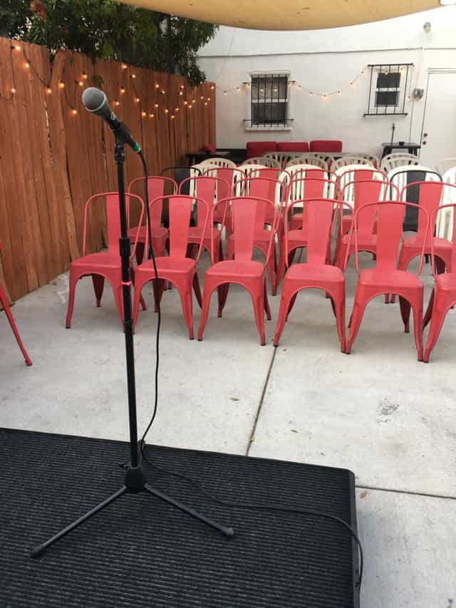 Outdoor patio with red chairs for an intimate gathering in Los Angeles, perfect for networking.