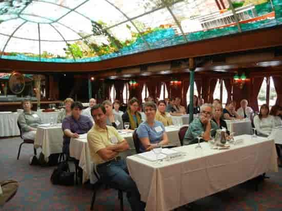 William D. Evans presenting in a Bahia Resort Hotel meeting space with stained glass ceiling.