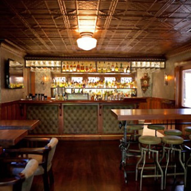 Elegant 1886 Bar with polished wood counter, ideal for networking events and gatherings.