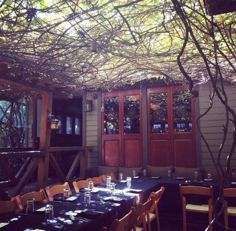 Cactus Garden at The Raymond 1886: cozy outdoor meeting space with rustic decor.