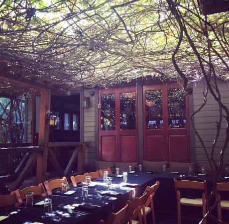 Cactus Garden at The Raymond 1886: cozy outdoor meeting space with rustic decor.