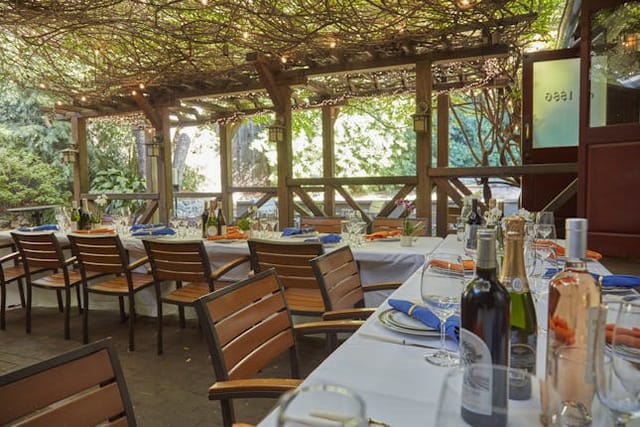 Outdoor dining at Fireside Terrace, The Raymond 1886, ideal for events and gatherings.