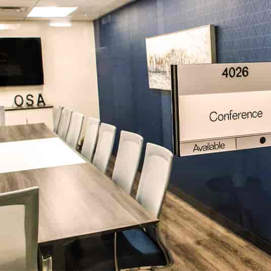 Modern conference room with sleek table, ideal for corporate meetings and events.
