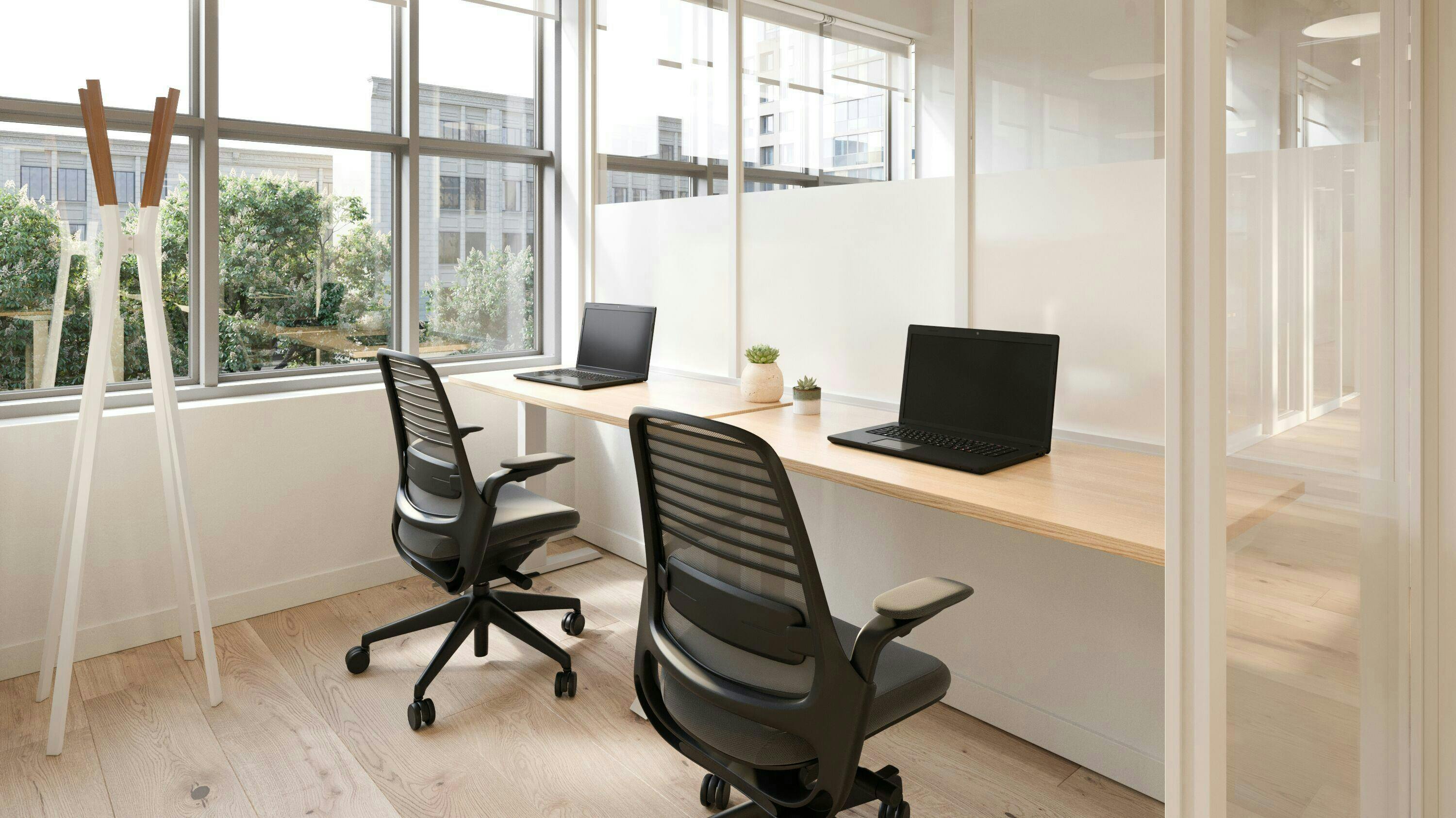 Modern private executive office with natural light, ideal for meetings and collaboration.