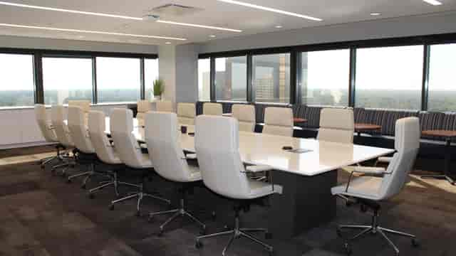 Modern conference room with large table, ideal for corporate meetings and events.