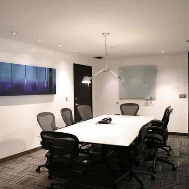 Modern conference room with sleek table, ideal for meetings and collaboration events.