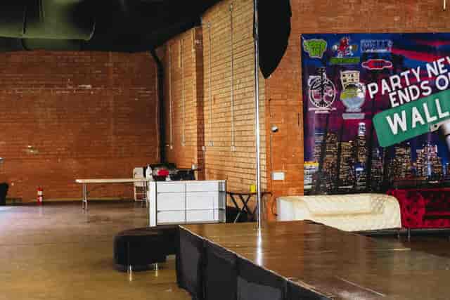 Versatile event space with exposed brick, ideal for gatherings and presentations.