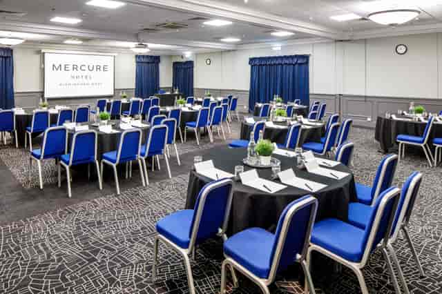 Meeting space at Mercure Birmingham West Hotel with projector screen for events.