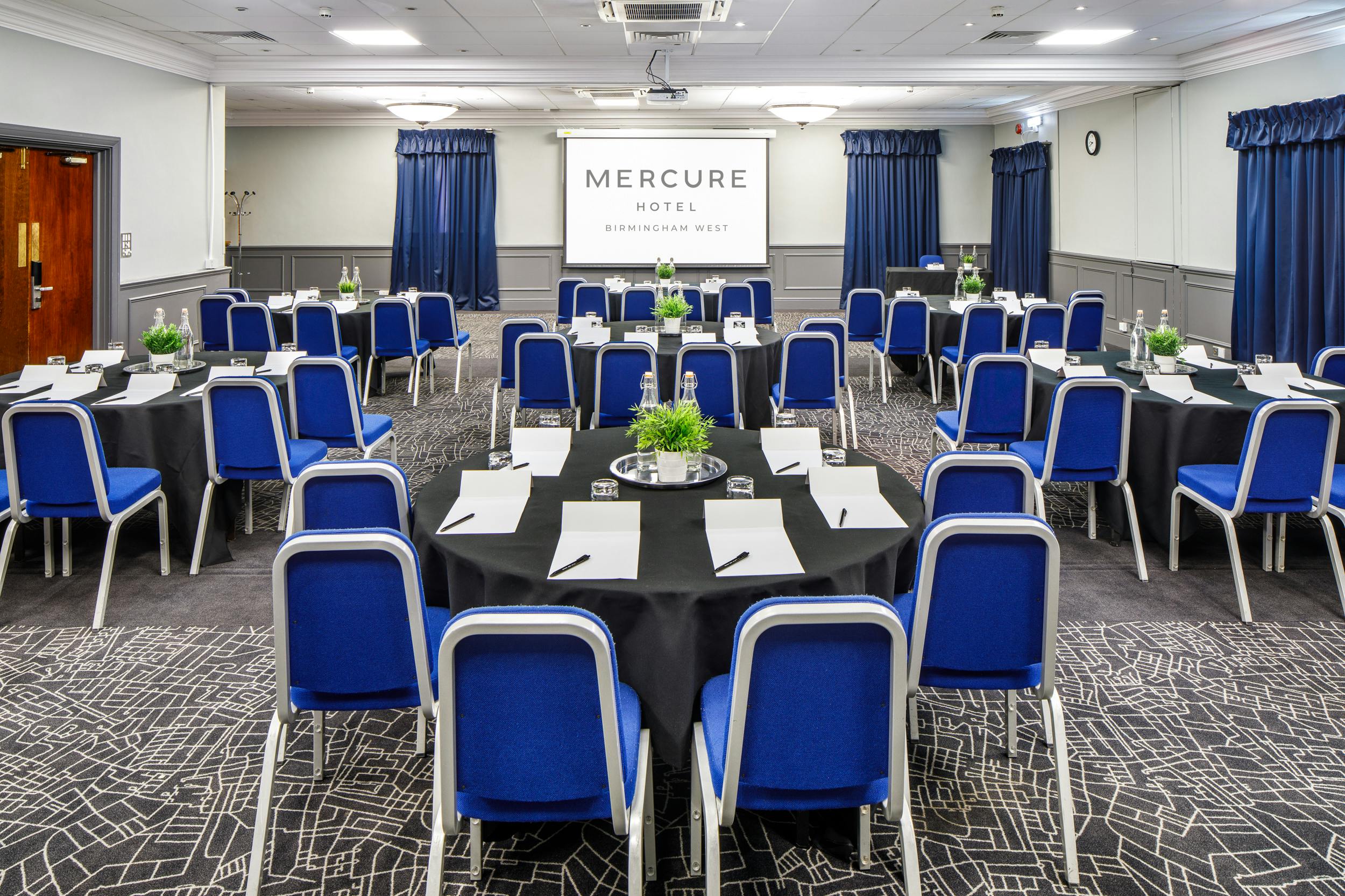 Prince of Wales at Mercure Birmingham: corporate meeting room with round tables and projector.