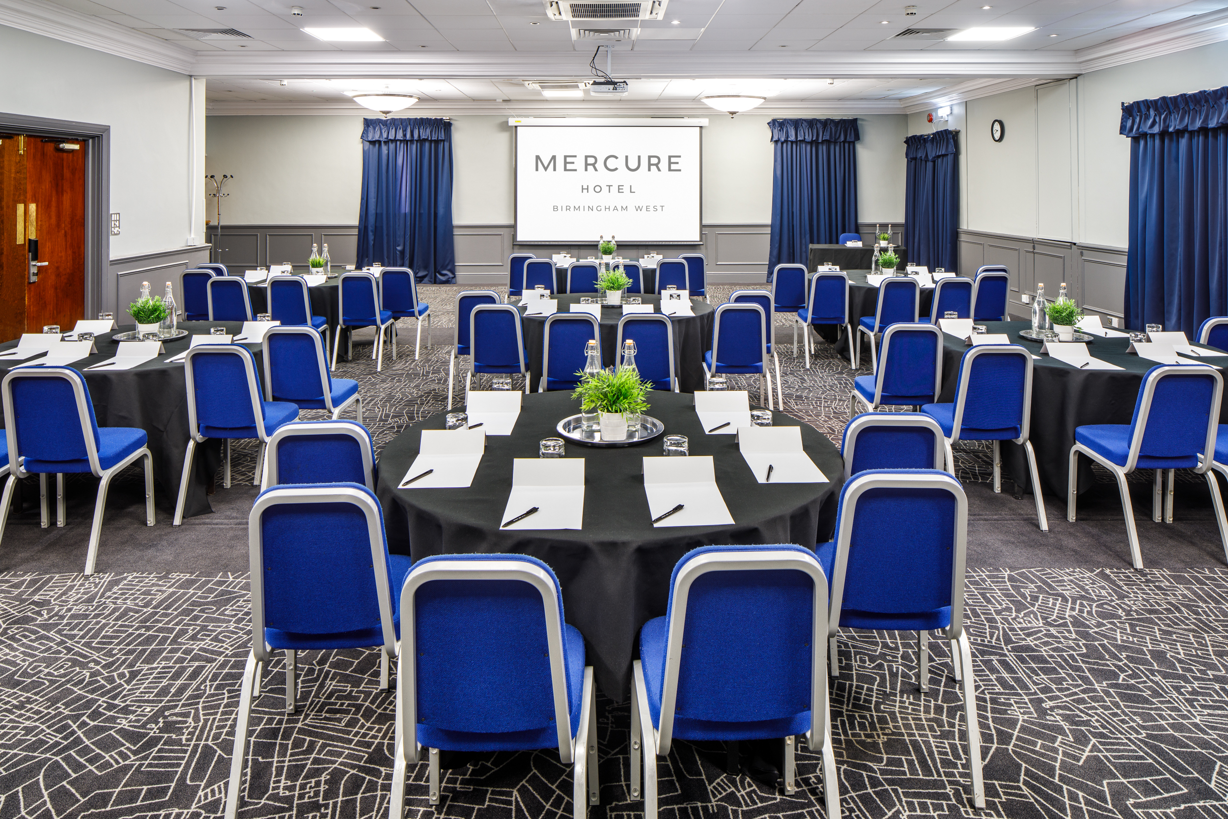 Prince of Wales at Mercure Birmingham: corporate meeting room with round tables and projector. - Banner