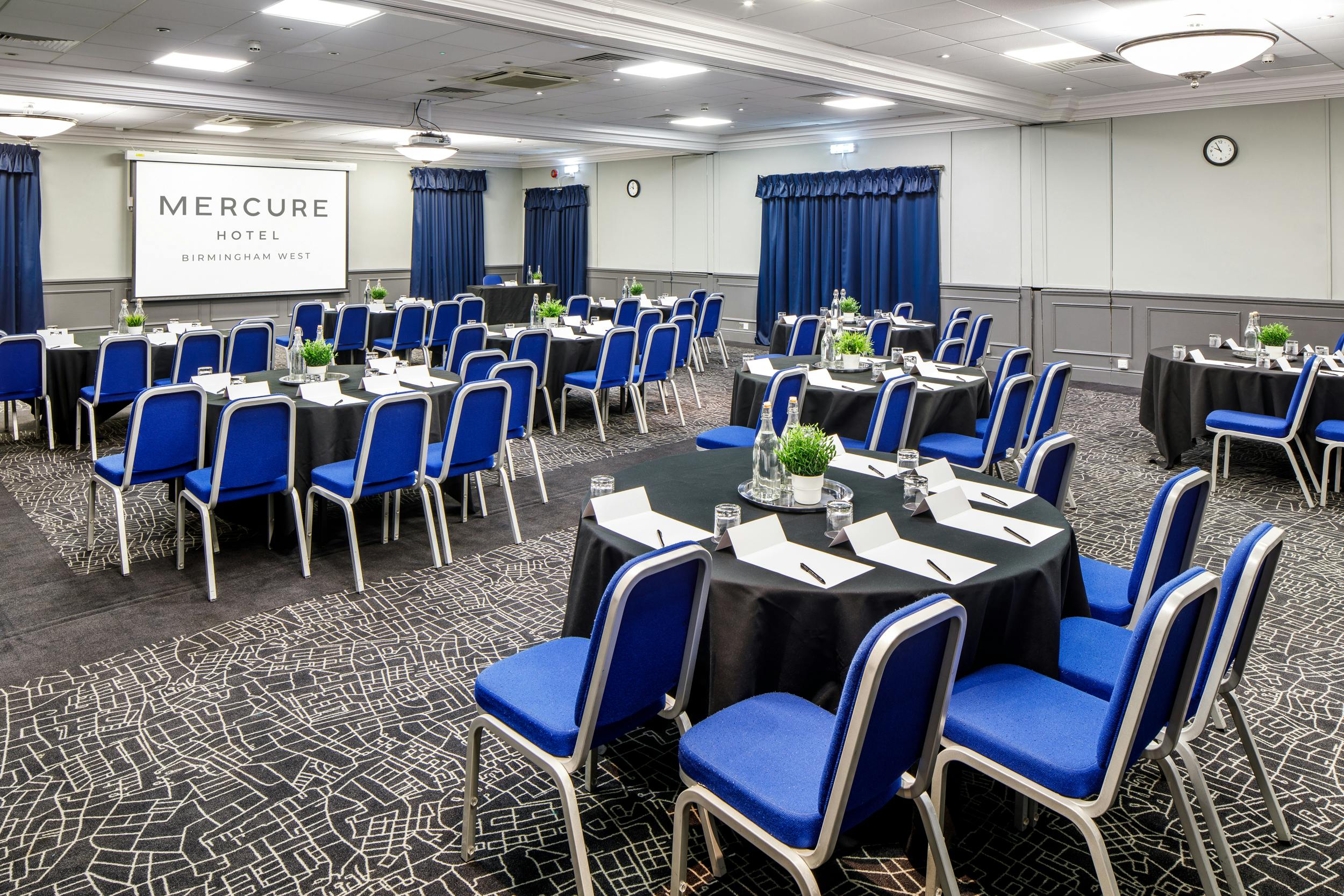 "Meeting space at Mercure Birmingham West Hotel with audio-visual setup for events."