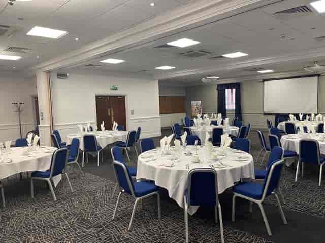Prince of Wales at Mercure Birmingham: elegant event space with round tables and projector.