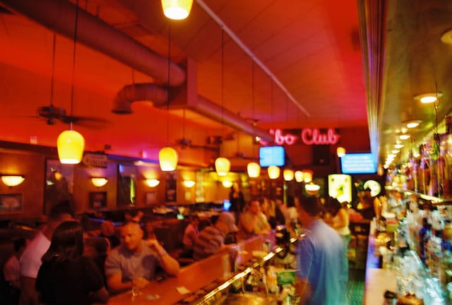 Vibrant bar with warm lighting, ideal for networking events and social gatherings.