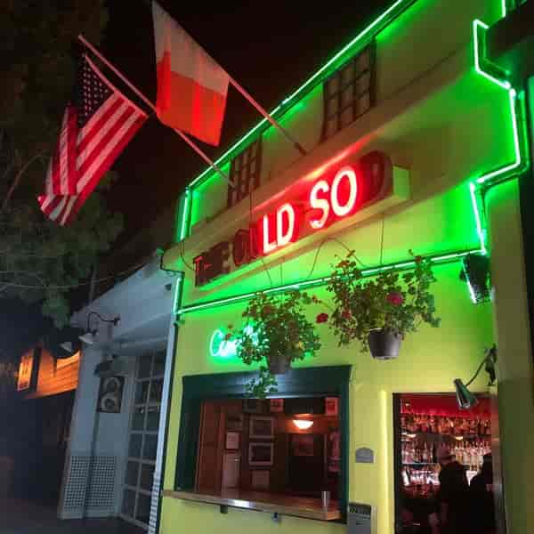 Vibrant bar exterior with neon lights, perfect for casual gatherings and themed events.