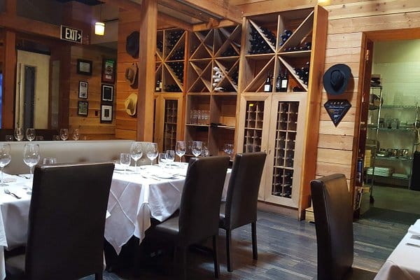 Cozy dining area with wood accents at The Wine Pub, ideal for private dinners and events.
