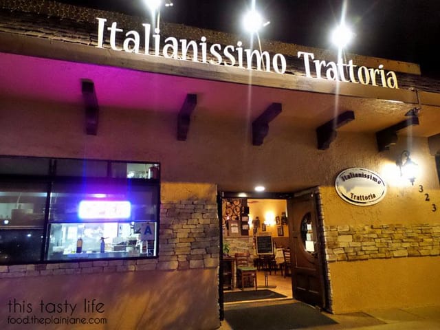 Cozy Italian restaurant bar with warm lighting, perfect for gatherings and meetings.