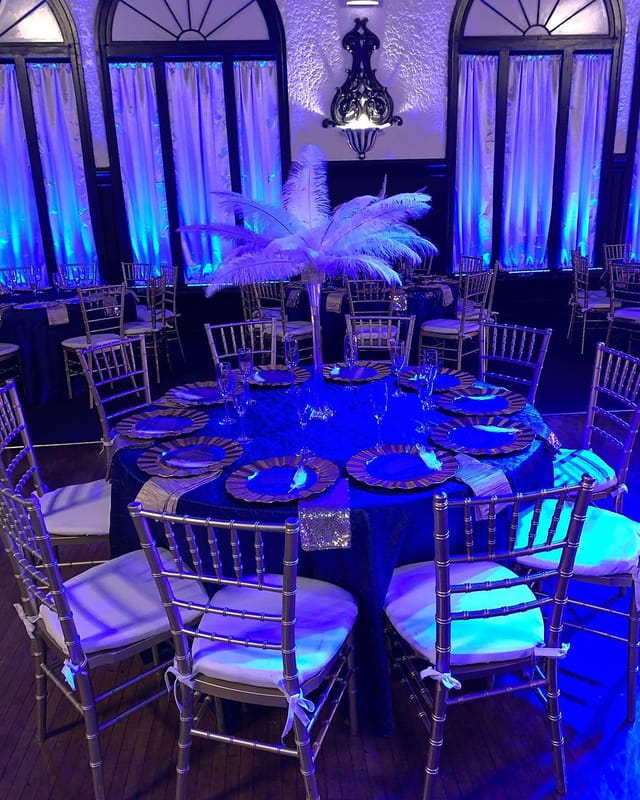 Elegant banquet table with feather centerpiece in Montebello Ballroom for weddings and galas.