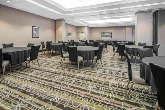 Lounge at La Quinta Inn: versatile event space with round tables for meetings and gatherings.