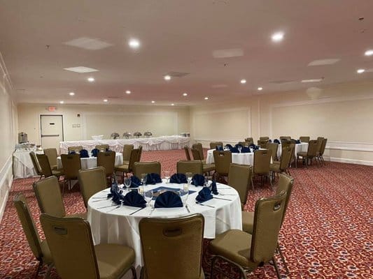 Elegant banquet setup at The Regency with round tables and navy blue accents.