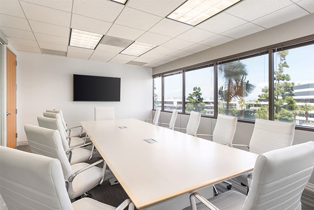 Modern conference room with large table, ideal for corporate meetings and presentations.