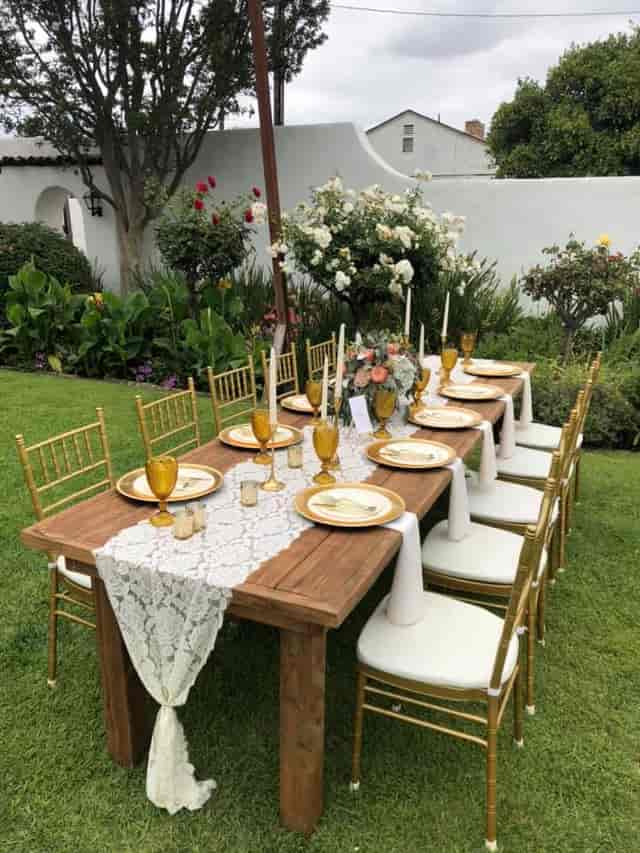 Elegant outdoor dining table with gold accents for upscale events at Casa de Parley Johnson.