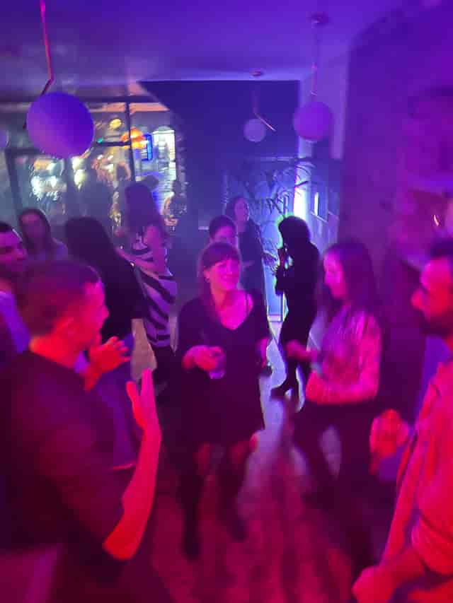 Vibrant social event at Mosaic Clapton Wine Bar with diverse attendees celebrating milestones.