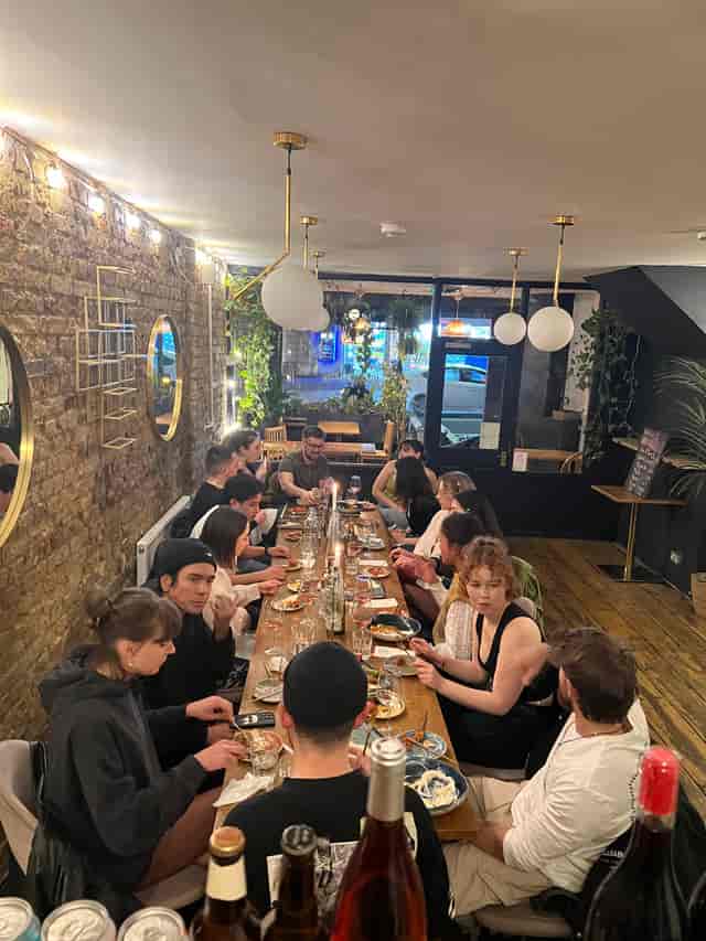 Lively group dining at Mosaic Clapton Wine Bar, ideal for networking and team-building.