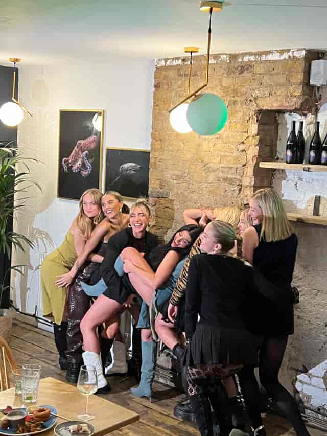 Vibrant women enjoying a lively event at Mosaic Clapton Wine Bar, perfect for celebrations.