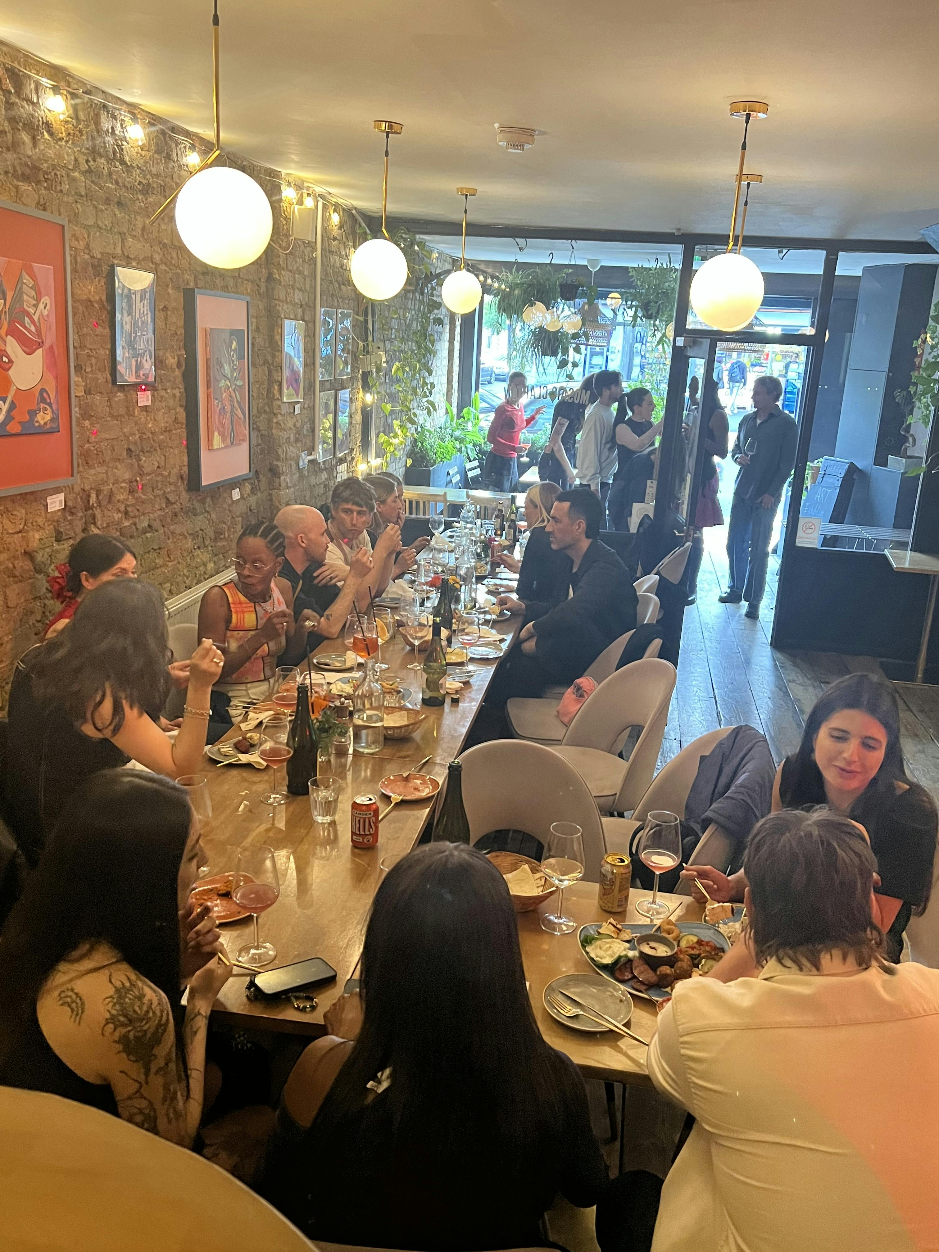 Mosaic Clapton Wine Bar dinner event with guests enjoying food and drinks, ideal for networking.